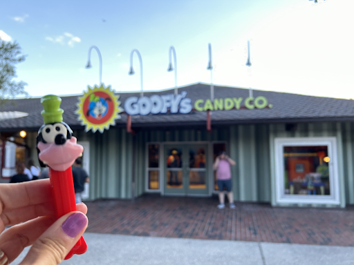 Goofy PEZ dispenser held up in front of Goofy's Candy Co.