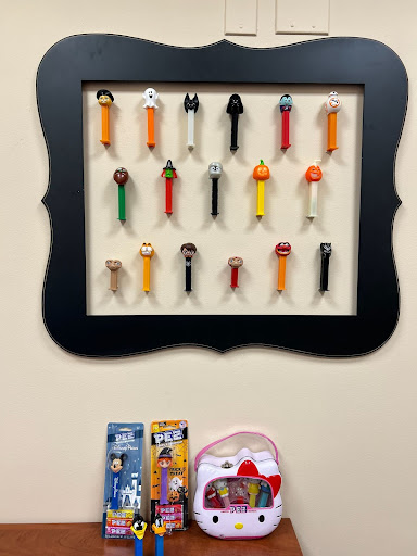 PEZ collection displayed in a frame.